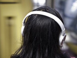 back view of woman wearing headphones