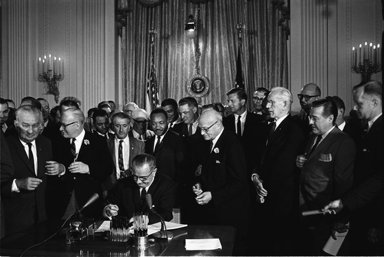 photo of President Lyndon Johnson signing the Civil Rights Act.