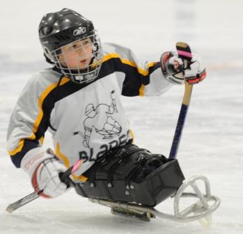 child playing sled hockey