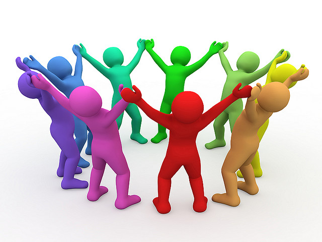 cartoon multi-colored characters in circle holding upraised hands