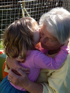 young child kissing old woman