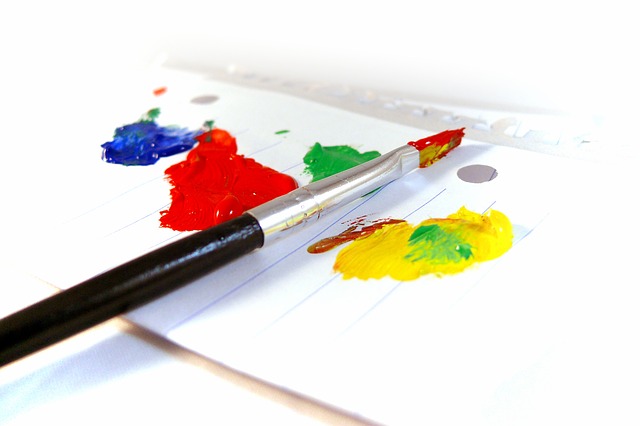 paint brush and blue, red, green and yellow paint